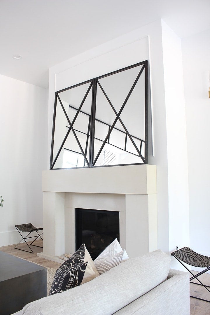 grid of mirrors leaning on mantle over fireplace