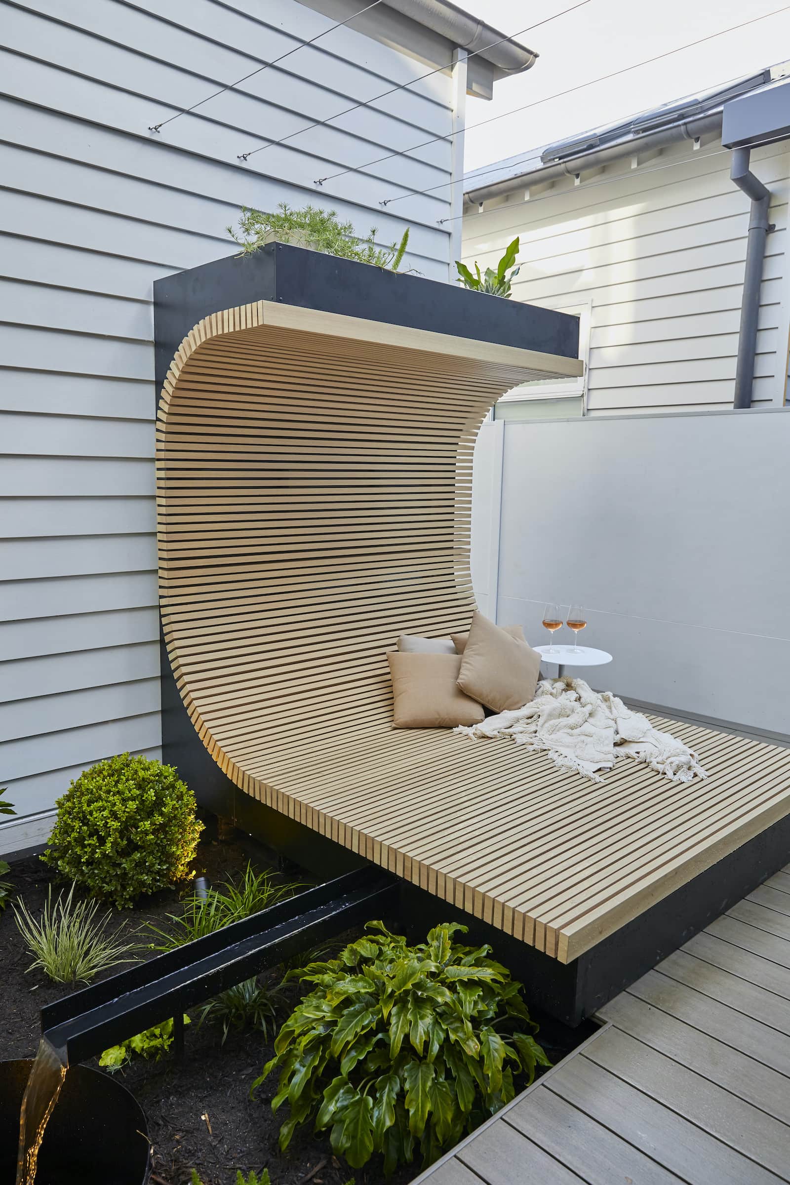 the block 2020 luke and jasmin curved daybed in backyard