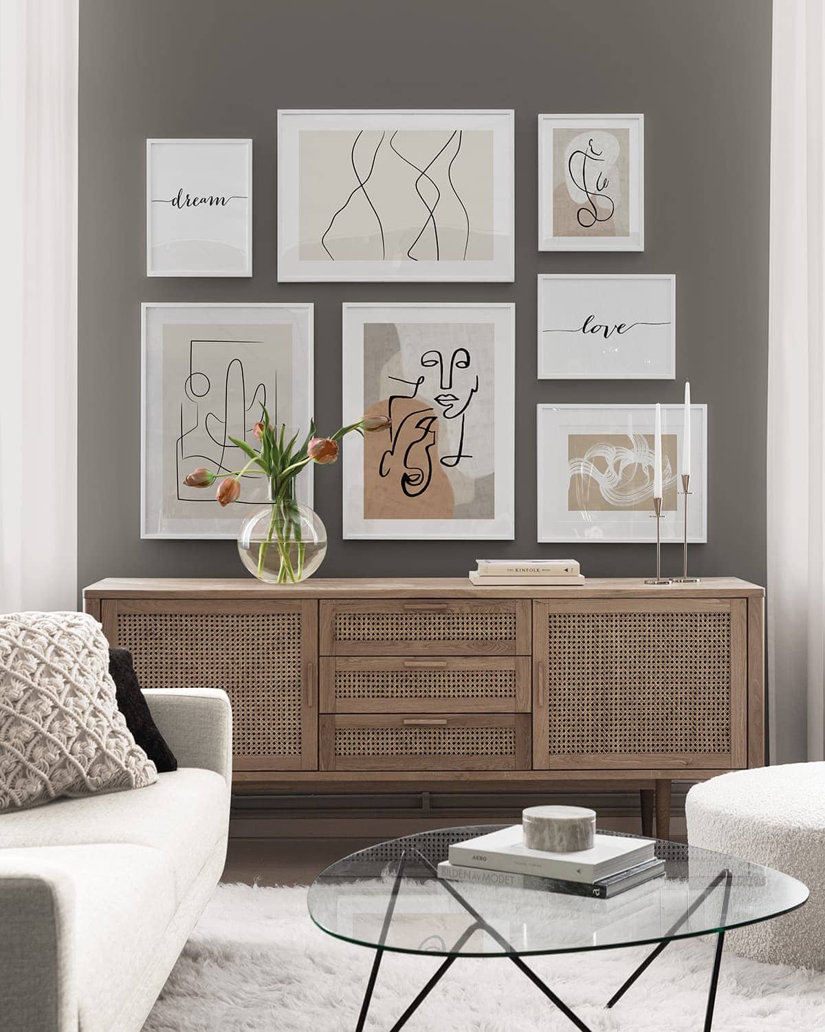 desenio minimalist artworks gallery wall on olive green wall in living room with rattan sideboard
