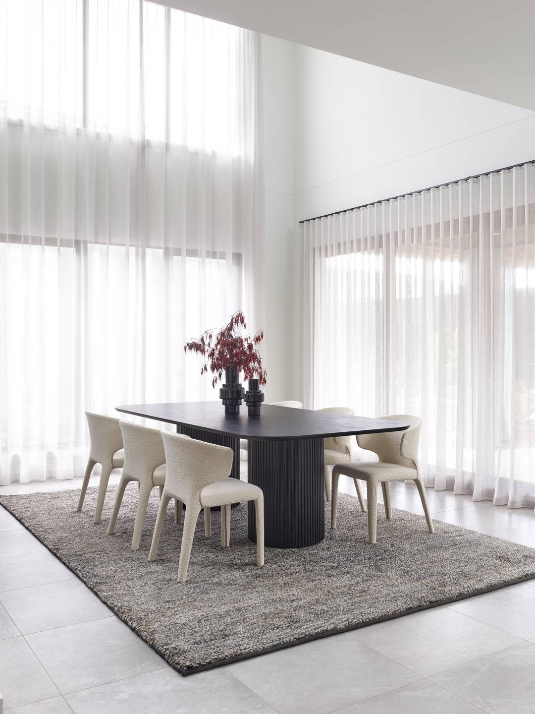 dining room with high ceilings white sheer curtains on windows