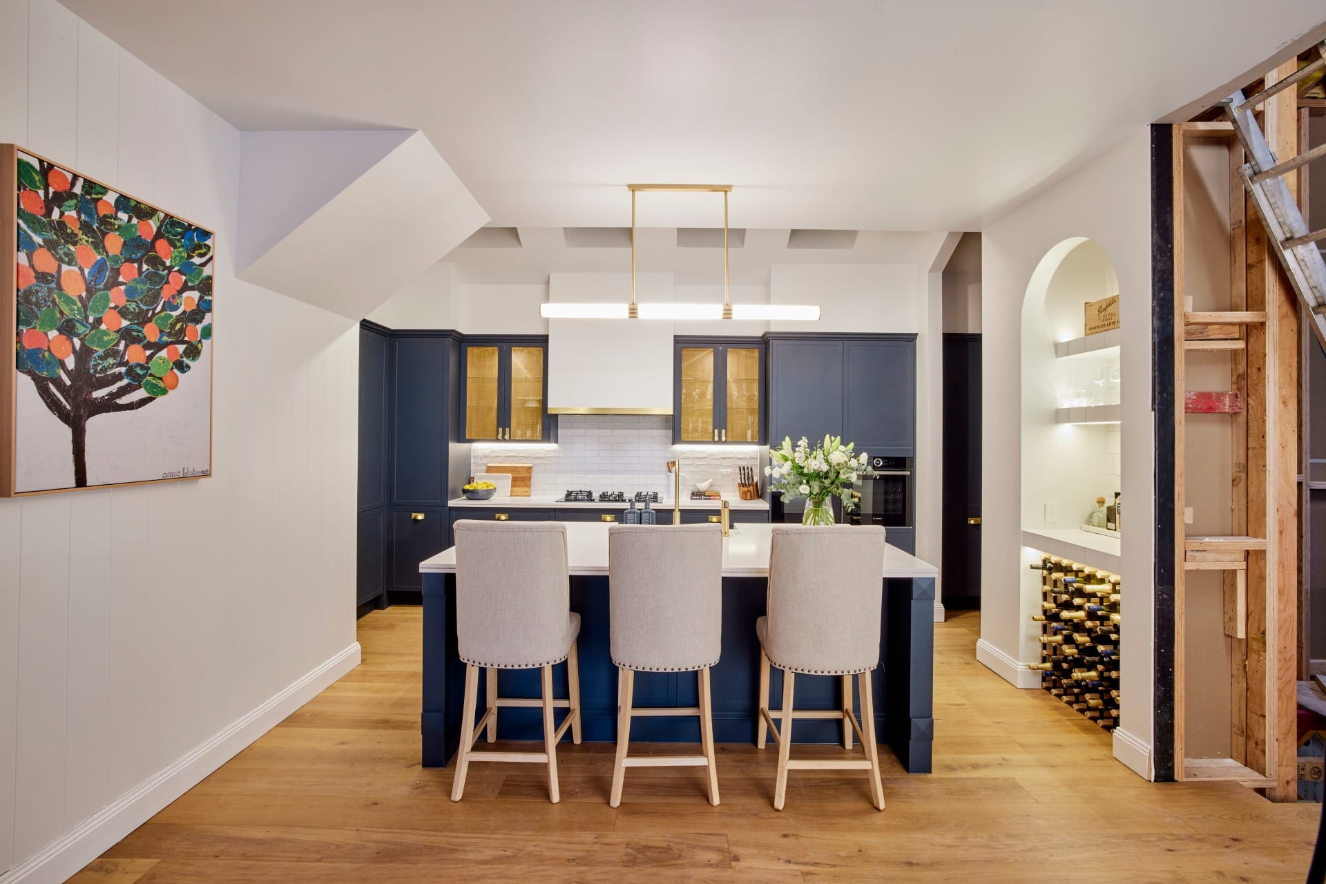 the block 2021 kirsty and jesse hamptons kitchen with blue cabinets and brass handles