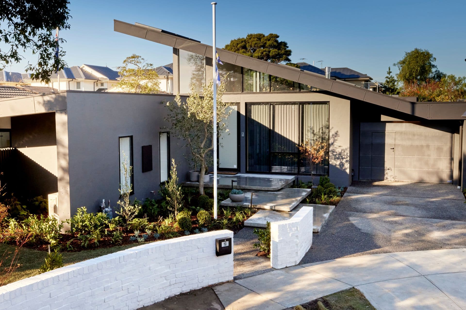 the block 2021 josh and luke front yard grey and white modern home facade