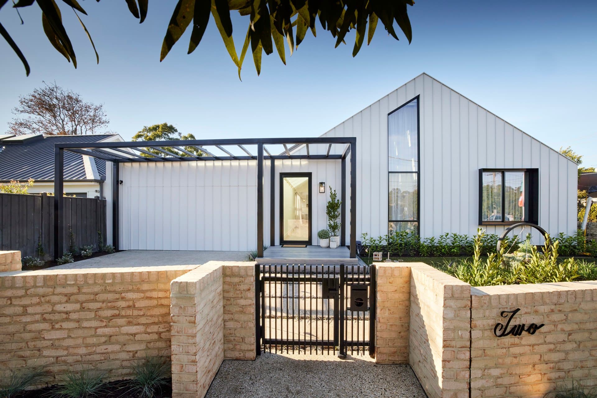 the block 2021 ronnie and georgia front yard white and black modern home facade