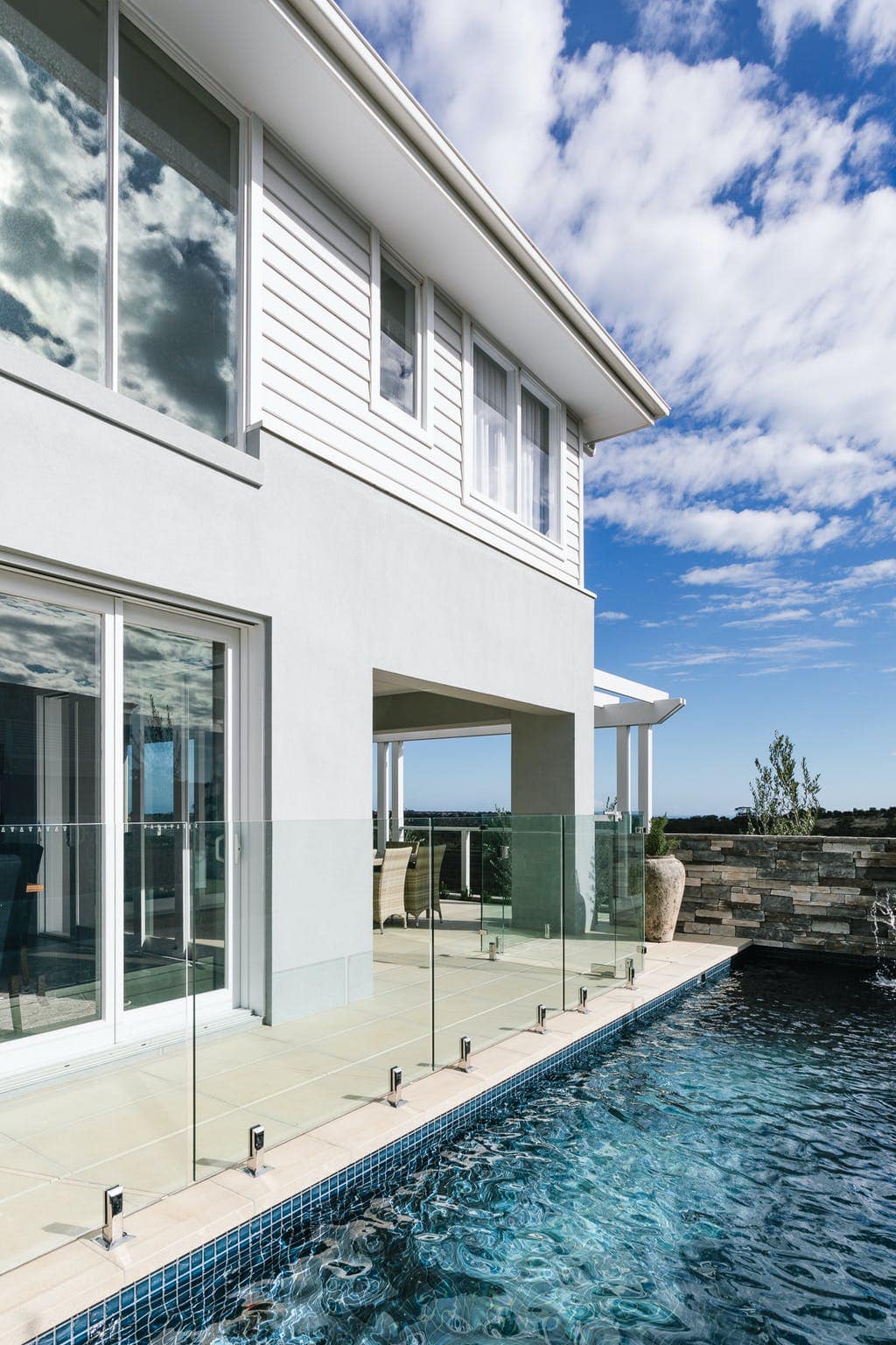 grey and white hamptons home facade and indoor swimming pool metricon