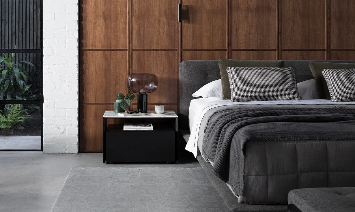 king living encore bed in mans bedroom with walbut wall panels