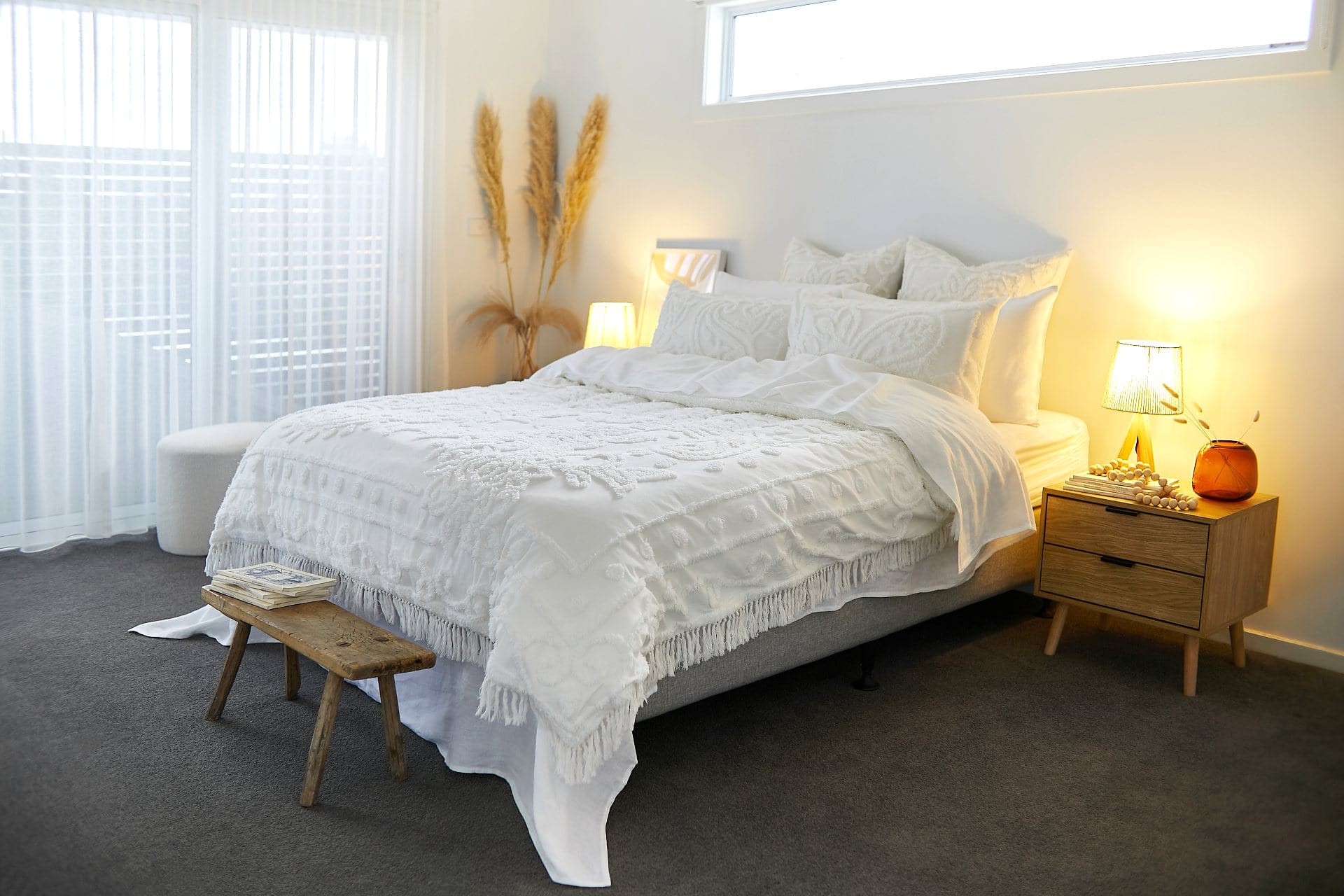 boho bedroom with white textured quilt cover set and blonde timber bedside table