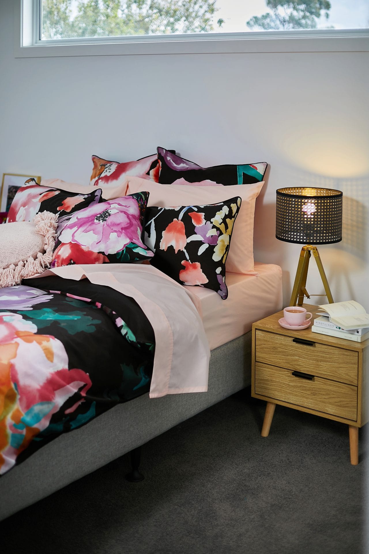 lorraine lea black and floral quilt cover set and round pink cushion with tassels