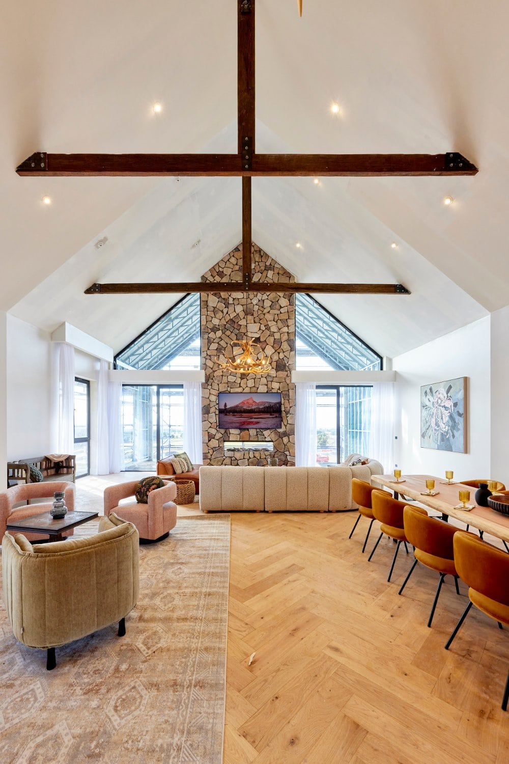 the block 2022 ankur and sharon living room with stack stone fireplace and vaulted ceiling
