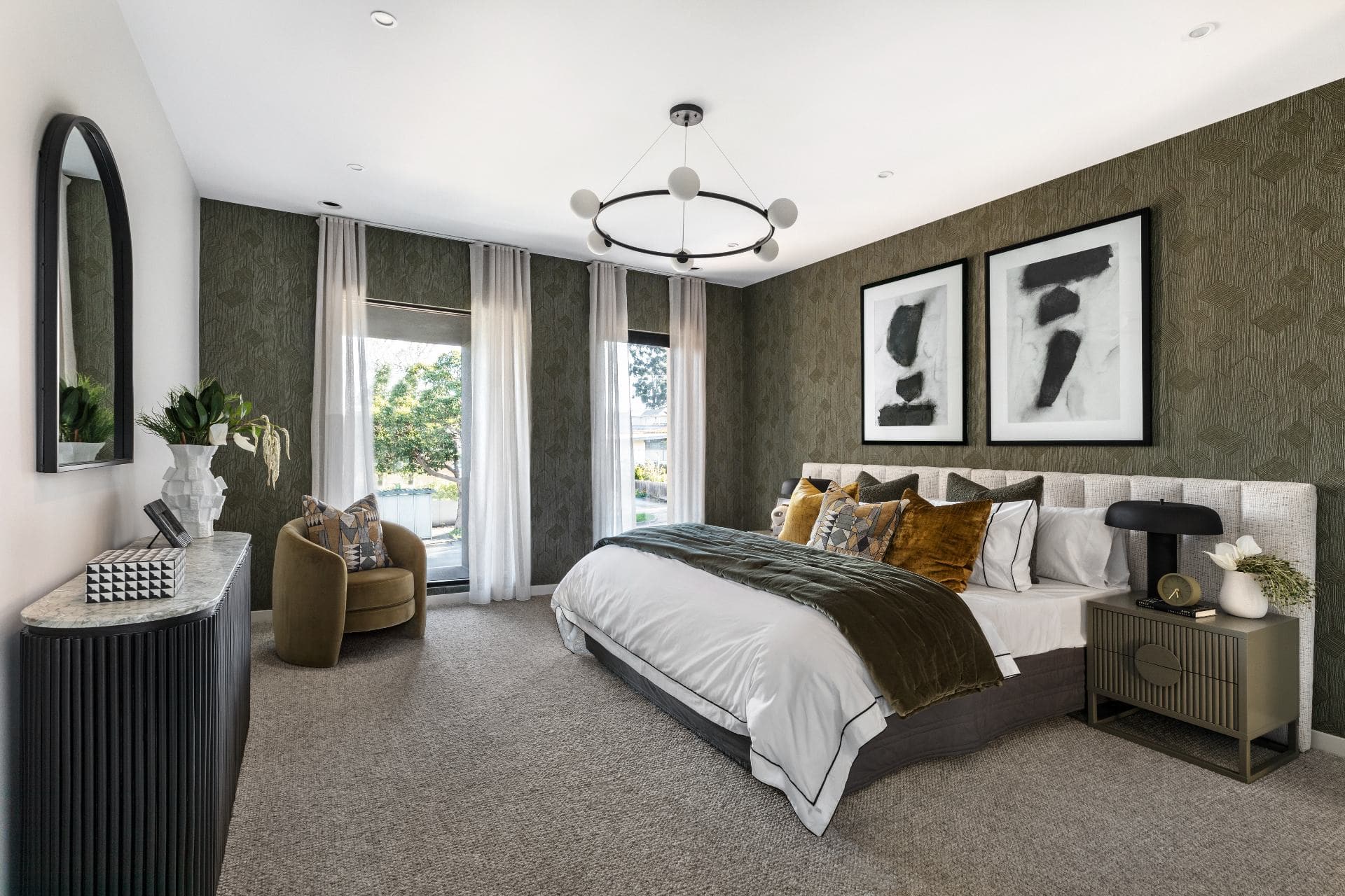 metricon lumiere bedroom with extra wide upholstered headboard and moody dark green wallpaper