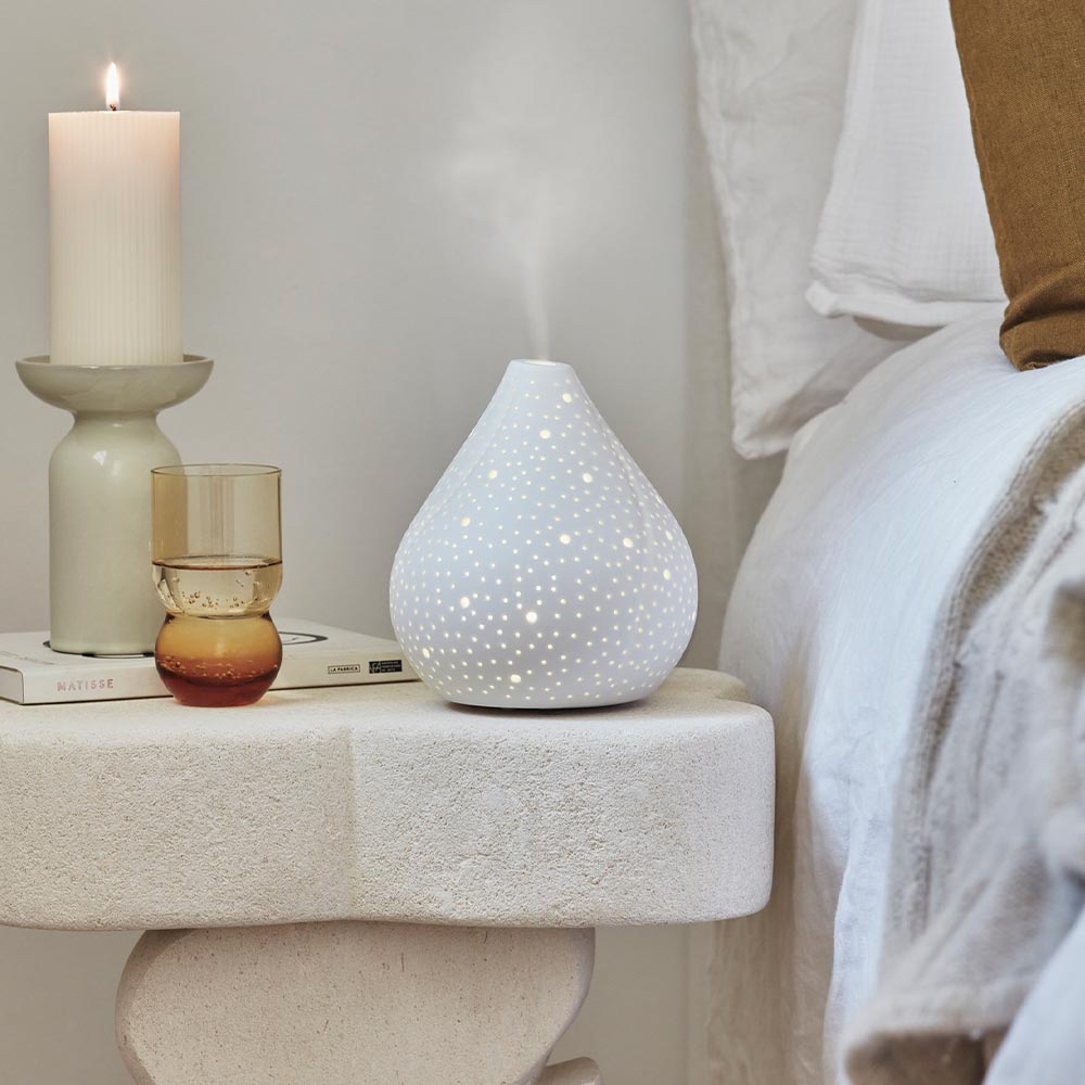 dusk scented candle diffuser on white stone bedside table