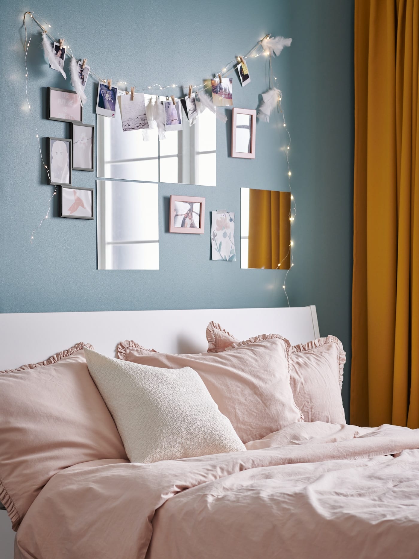 ikea mirror pack on rental bedroom wall with fairy lights