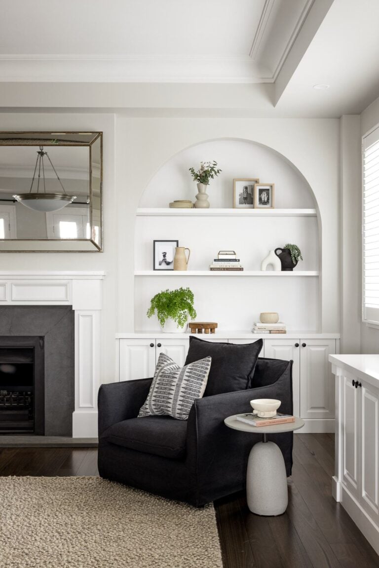 modern country living room with arched shelves and fireplace black fabric armchair in corner