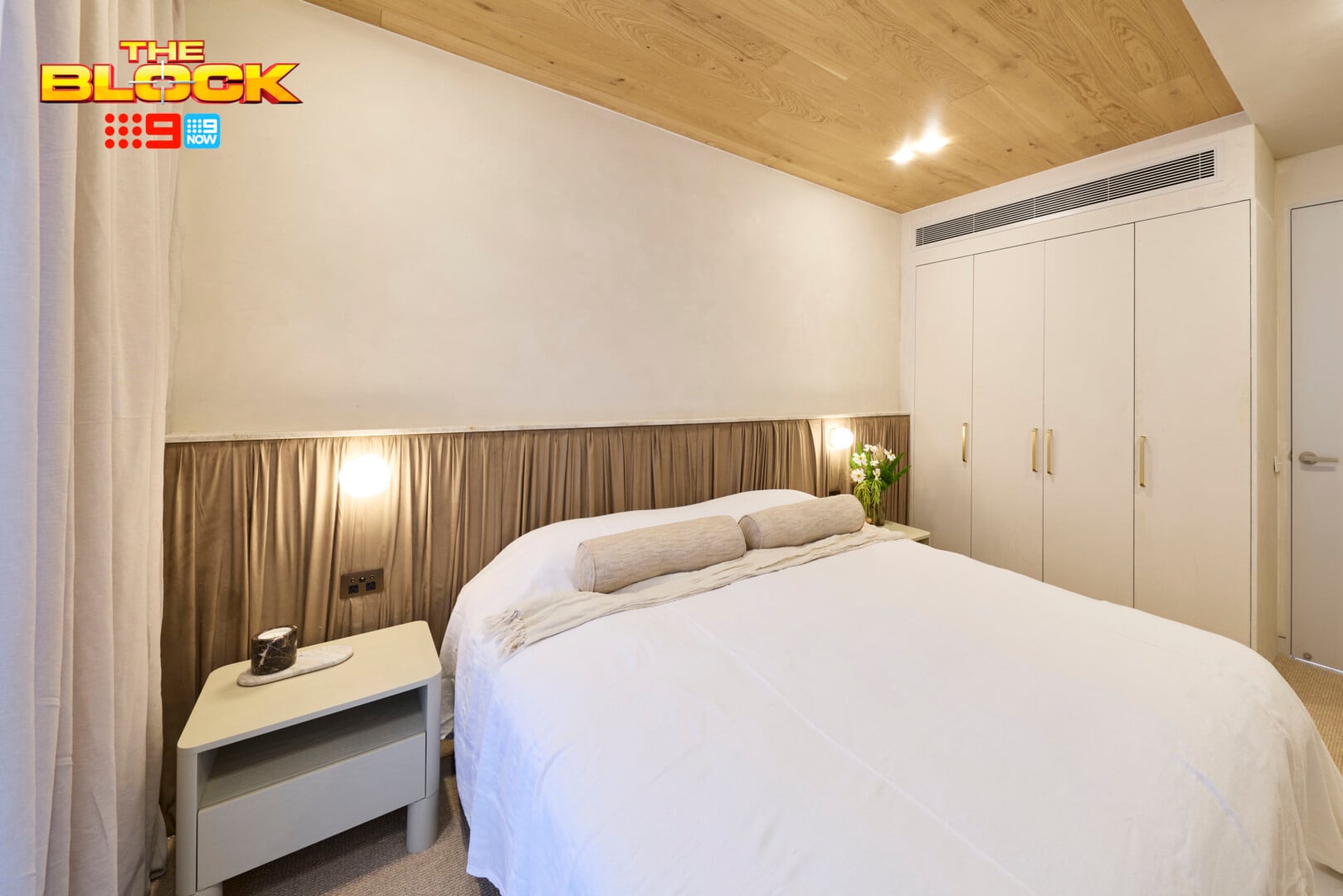 The Block 2026 Guest Bedrooms Reveal: Bland Beginnings for Week One 3 the block 2026 guest bedroom reveal courtney and sev bed with fabric draped behind it